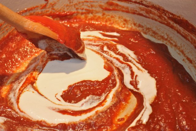 tikka masala sauce being prepped in a red bowl