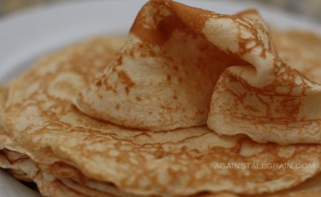 gluten free tortillas folded up on a plate ready to be added to another dish