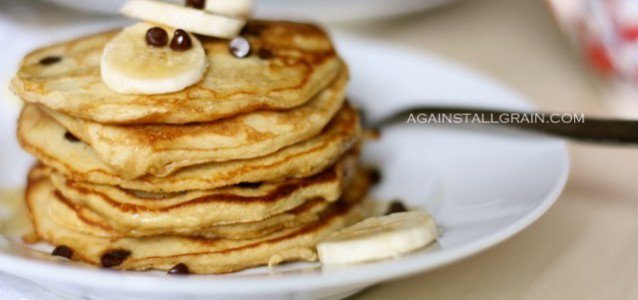 gluten free pancakes with bananas and butter on top and maple syrup.