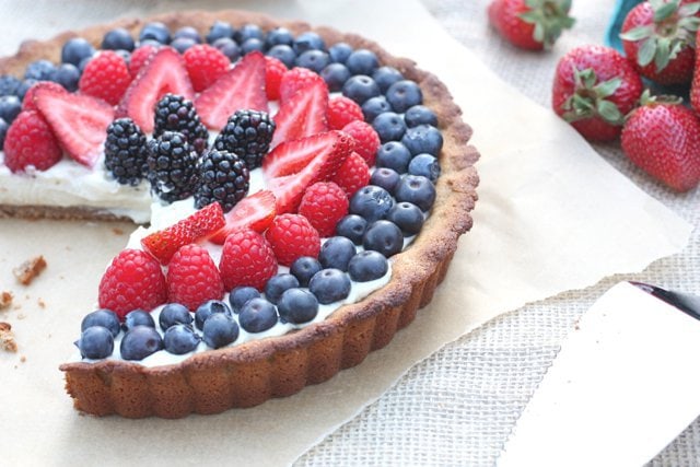 Delicious and sweet red, white and blue berry tart with dairy free vanilla bean custard.