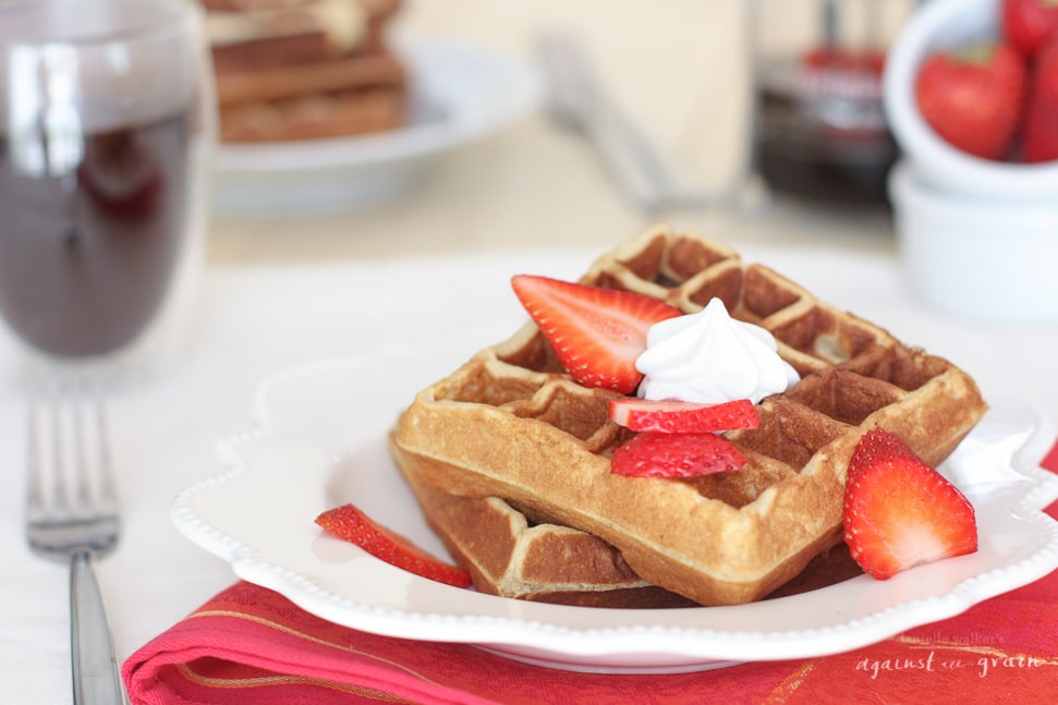 Grain Free Waffles topped with strawberries and cream.