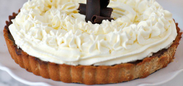 Rich and Creamy Chocolate Pudding Pie topped with coconut milk whipped cream.
