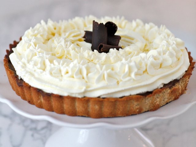 Rich and Creamy Chocolate Pudding Pie topped with coconut milk whipped cream.