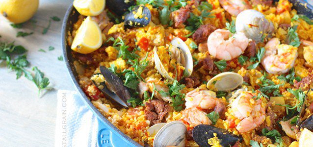 An aromatic pan of mixed seafood paella with cauliflower rice and saffron.