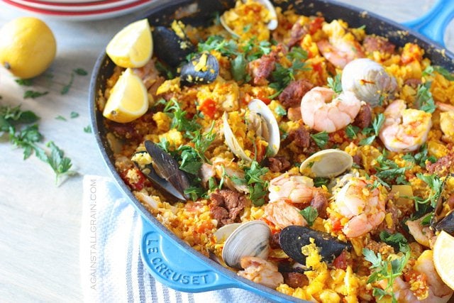 An aromatic pan of mixed seafood paella with cauliflower rice and saffron.