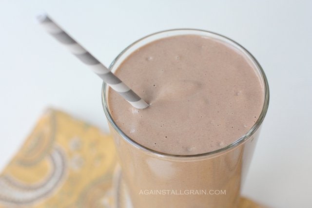 healthy chocolate smoothie in a glass with a straw