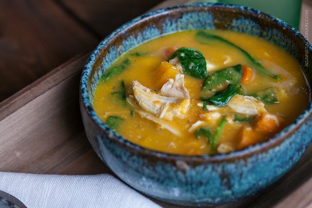 Roasted Chicken Soup in a rustic blue bowl set on a wooden tray on a wooden table