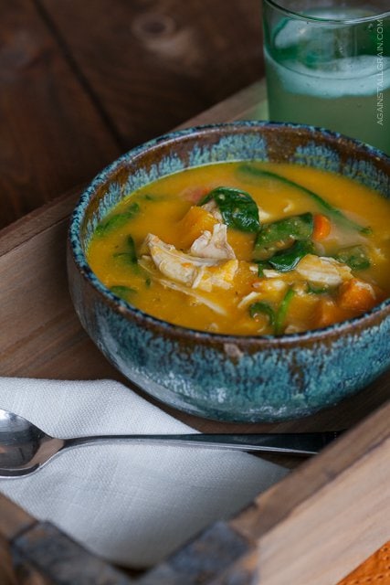 Roasted Chicken Soup in a rustic blue bowl set on a wooden tray on a wooden table