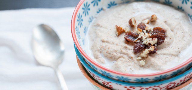 banana nut porridge in a decorative bowl with walnuts on top