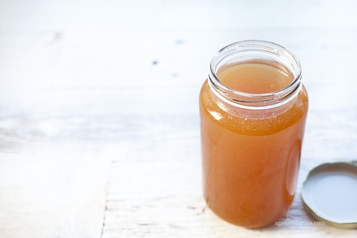 chicken bone broth in a mason jar with lid removed