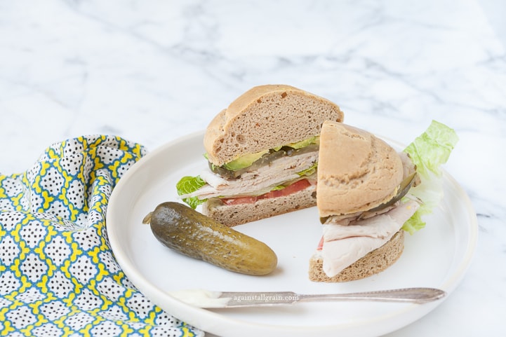 Flaky and delicious gluten free sandwich bun loaded with turkey, tomato and lettuce.