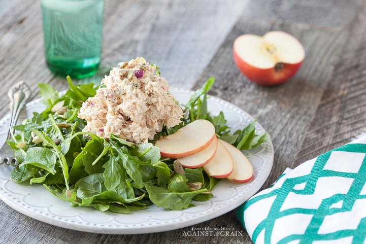 A delicious scoop of Tuna Salad with Apples and Pumpkin Seeds on a bed of lettuce.