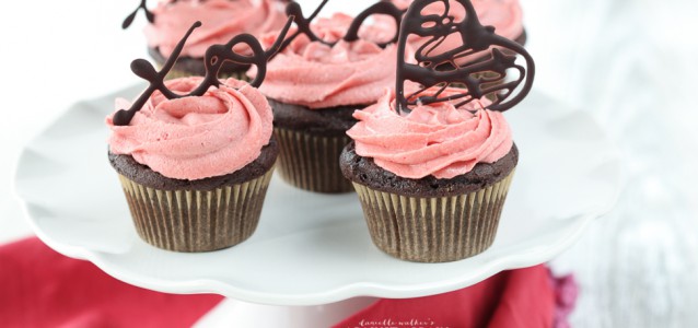 Beautifully decorated chocolate cupcakes with strawberry icing that are gluten and dairy free.