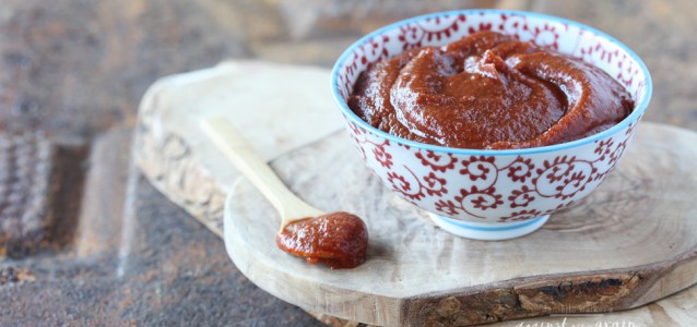 paleo bbq sauce in a dish on top of a cutting board