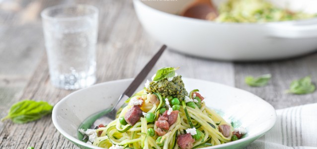 A delectable bowl of Spiralized Zucchini Pesto Pasta with Peas and Pancetta.