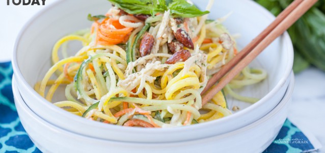 A bowl of Tangled Thai Salad using spiralized beets, cucumber, jicama, and carrots with a tangy and spicy Thai dressing.