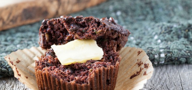 moist chocolate zucchini muffin with a dollop of butter