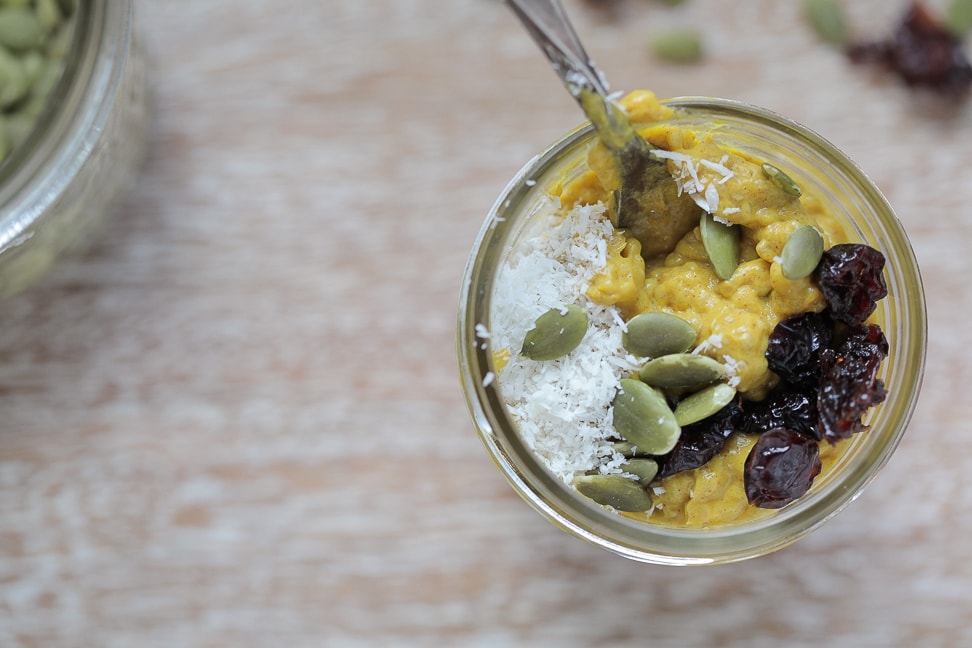 pumpkin chia seed pudding in a mason jar with a spoon sticking out