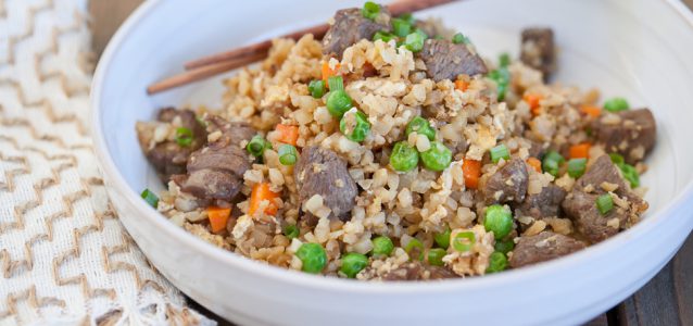 Cauliflower Fried Rice with Beef in a bowl and chopsticks placed into it