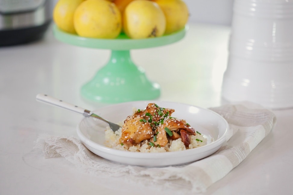 Instant Pot Sesame-orange chicken on a plate with a fork