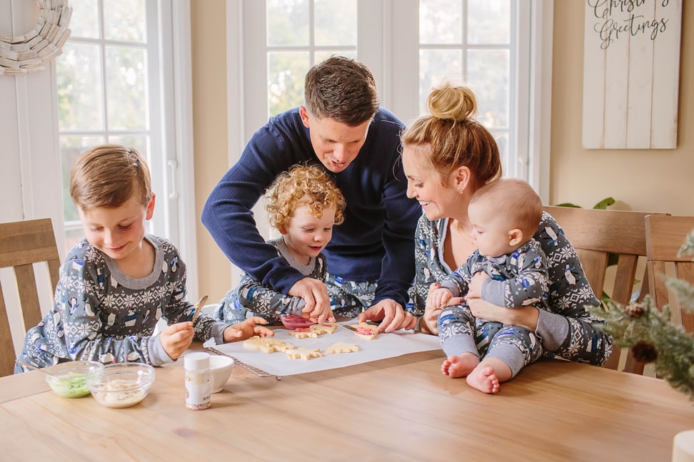 Danielle's family gathered around the table making cut out Christmas cookies that are nut free and dairy free!