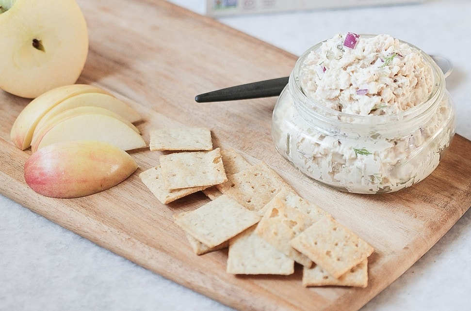 A jar of the best tuna salad (scd and whole30 approved) served with apples and crackers.