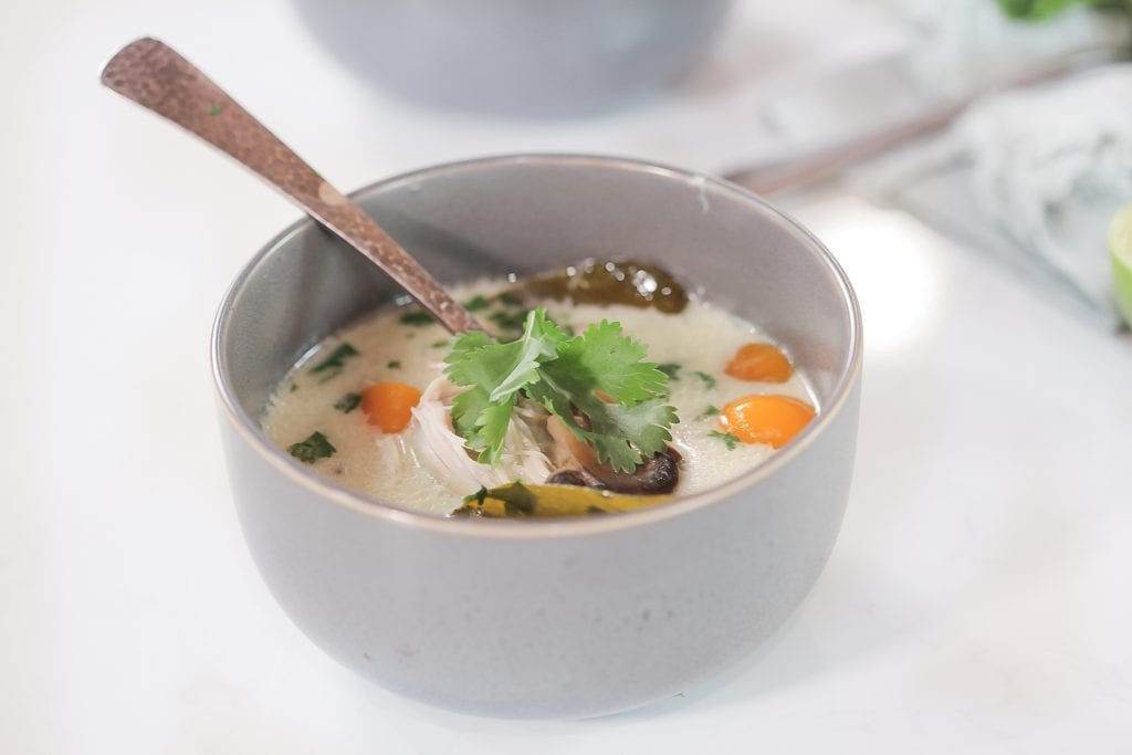 Creamy Thai coconut soup steaming in a bowl.