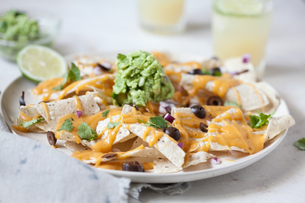 Paleo Nacho Cheese on a plate of tortilla chips