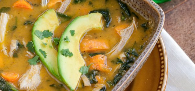 A steaming bowl of Instant Pot Mexican Chicken soup topped with avocado and cilantro.