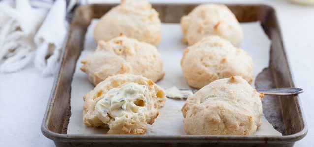 Grain-free Cheddar Biscuit Recipe with Chive Whipped Ghee on a sheet pan baked and ready to eat