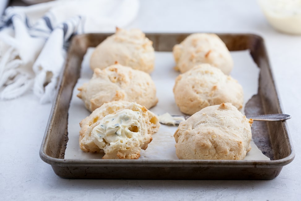 Grain-free Cheddar Biscuit Recipe with Chive Whipped Ghee on a sheet pan baked and ready to eat