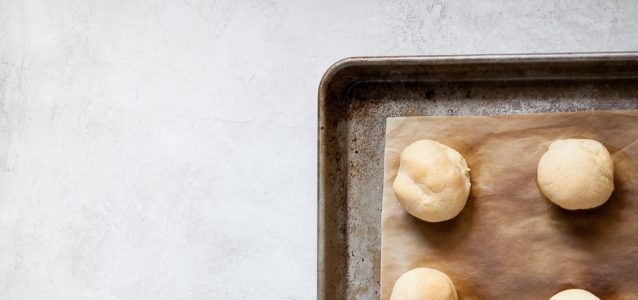gluten free Brazilian cheese bread on a sheet pan just coming out of the oven