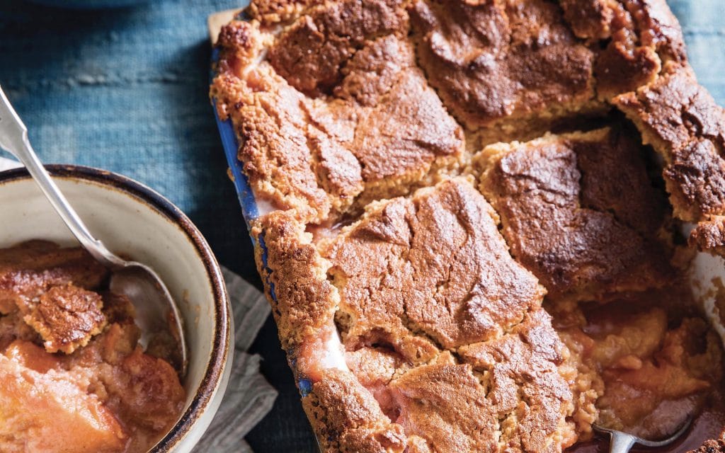 A pan of flaky gluten free peach cobbler right out of the oven!