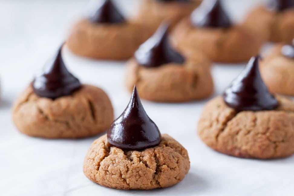 Gluten Free 'Peanut' Butter Blossom Cookies on a table with the chocolate looking amazingly good