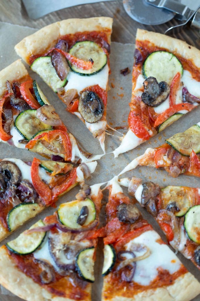 Gluten free pizza crust topped with a mix of sautéed zucchini, red onion, baby Bella mushrooms, and red bell pepper