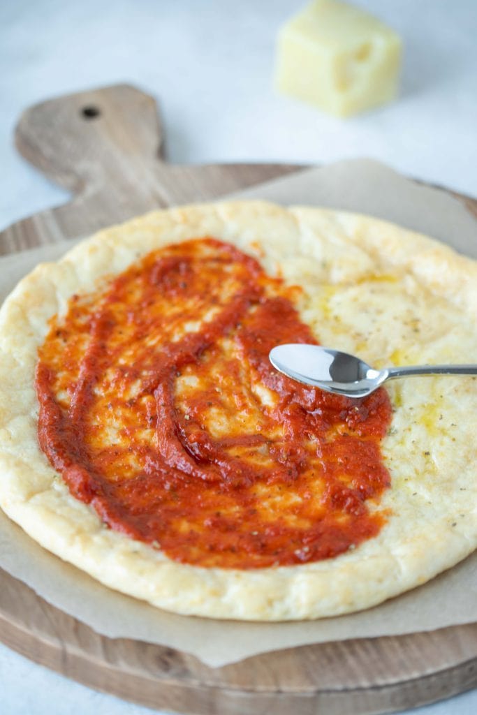 Fluffy gluten free pizza crust with a sauce