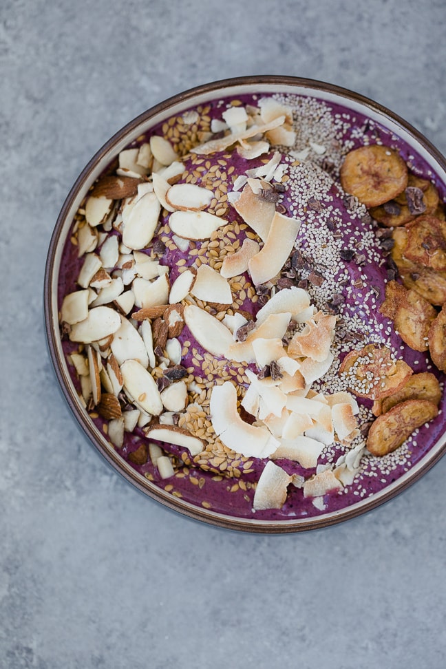 gluten-free acai bowl topped with a variety of grain free options such as almonds, coconut, chia seeds and plantain chips