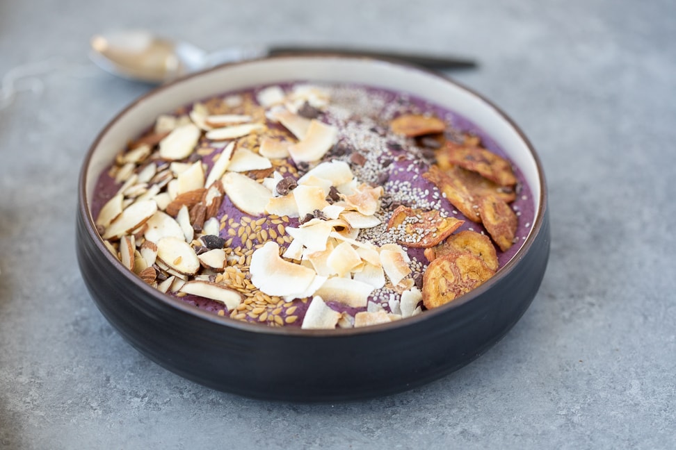 gluten-free acai bowl topped with a variety of grain free options such as almonds, coconut, chia seeds and plantain chips
