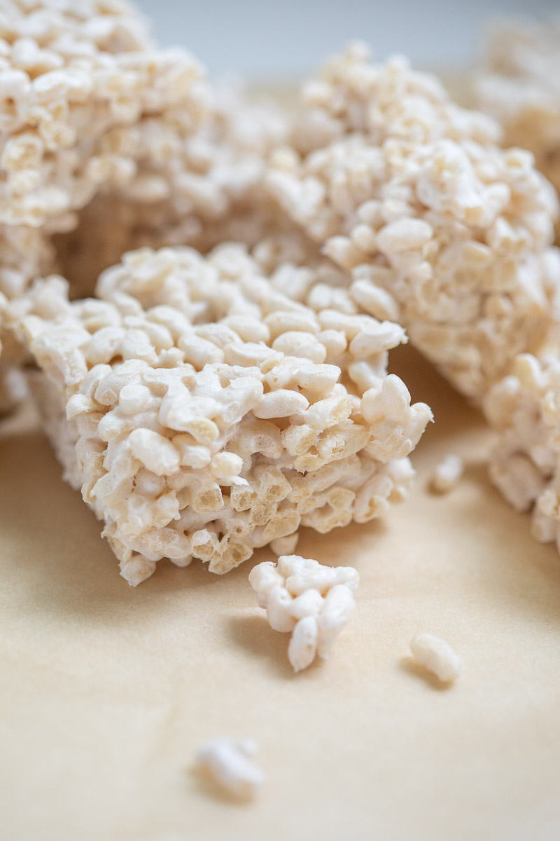 Sprouted Brown Rice Crispy Treats cut in squares and placed on parchment paper