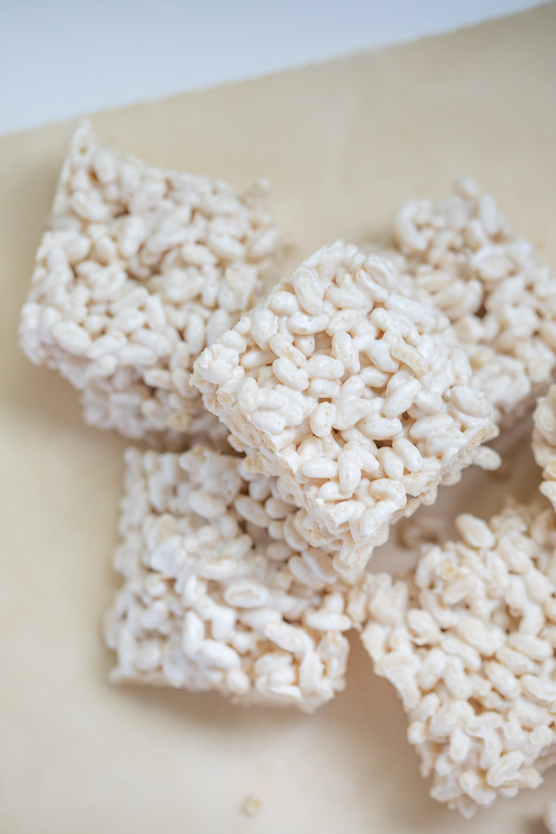 Sprouted Brown Rice Crispy Treats cut in squares and placed on parchment paper