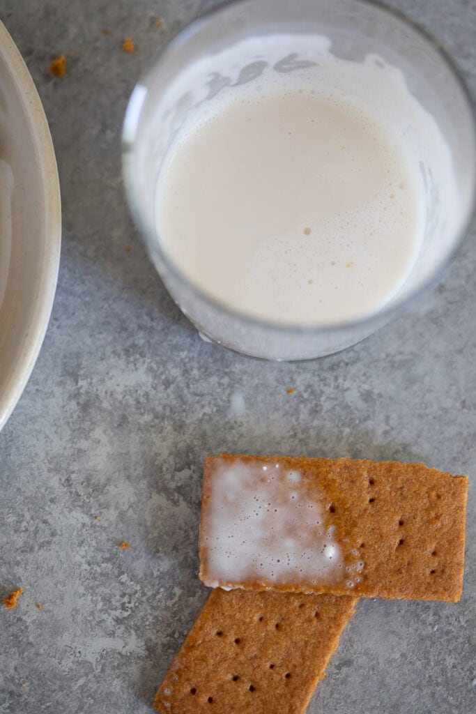 Homemade gluten freen graham crackers served with a glass of milk