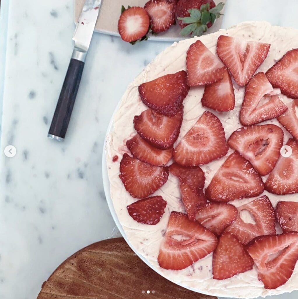 layer of cake with ice cream and fresh cut strawberries