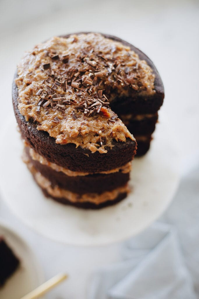 top vie of a 3 layer Gluten Free German Chocolate Cake. Top layer has shaved chocolate curls. 