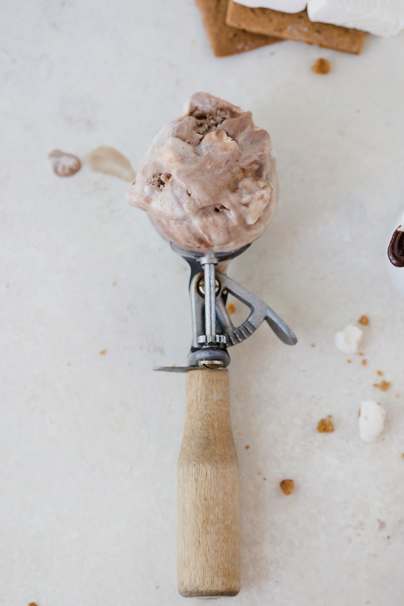 ice cream scoop full of dairy-free s'mores ice cream resting on counter 